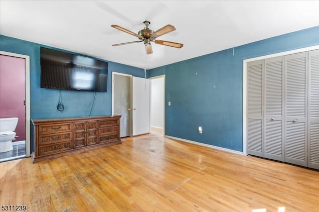 unfurnished bedroom with ensuite bath, light hardwood / wood-style flooring, and ceiling fan