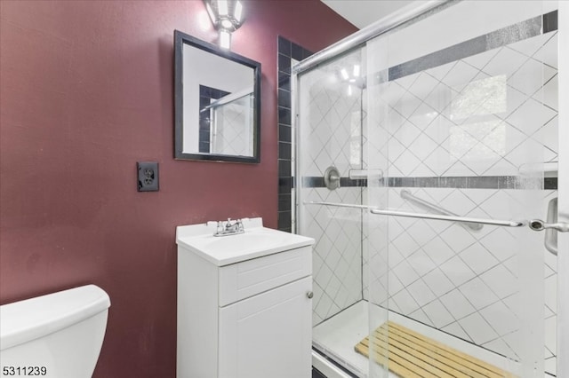 bathroom with vanity, toilet, and walk in shower