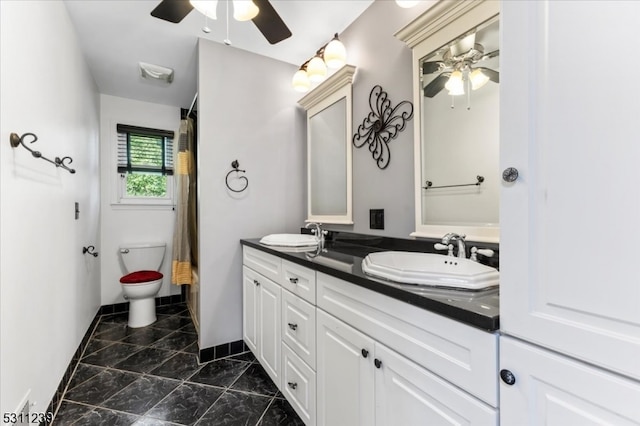 bathroom with vanity, ceiling fan, curtained shower, and toilet