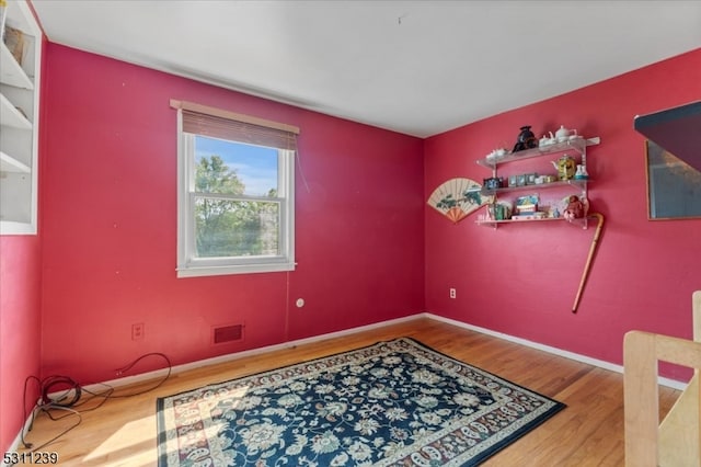 spare room with hardwood / wood-style flooring