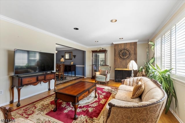 living room with hardwood / wood-style flooring, plenty of natural light, and ornamental molding