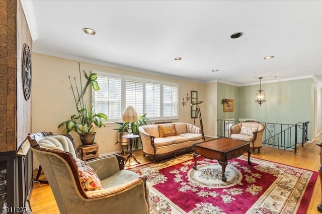 living room with ornamental molding and light wood-type flooring