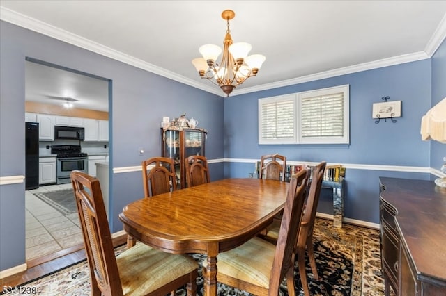 dining room with ornamental molding, a chandelier, and tile patterned floors