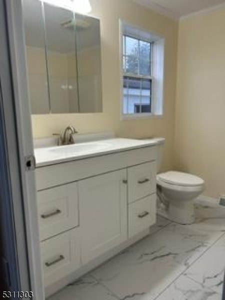 bathroom featuring vanity and toilet