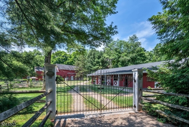 view of gate featuring a yard