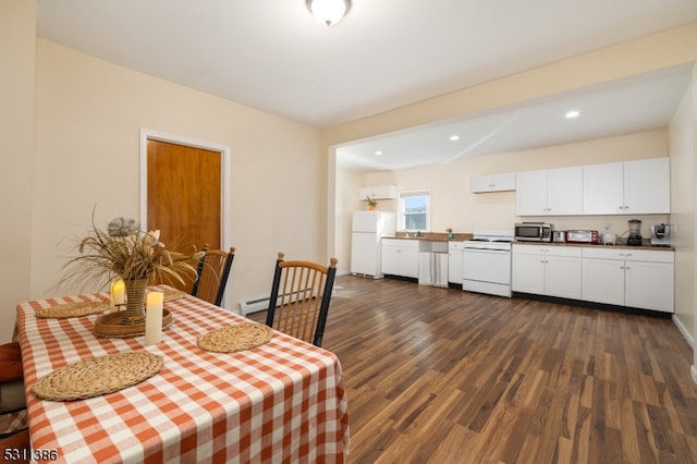 dining room with baseboard heating and dark wood-type flooring