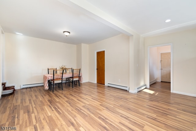 dining room with light hardwood / wood-style flooring and a baseboard heating unit