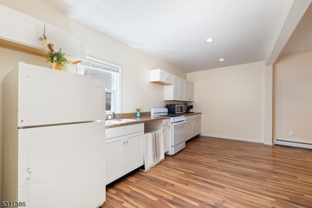 kitchen featuring sink, white cabinets, light wood-type flooring, and white appliances