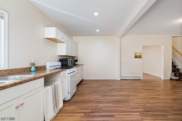 kitchen featuring white cabinets, a baseboard heating unit, hardwood / wood-style flooring, and white gas range oven