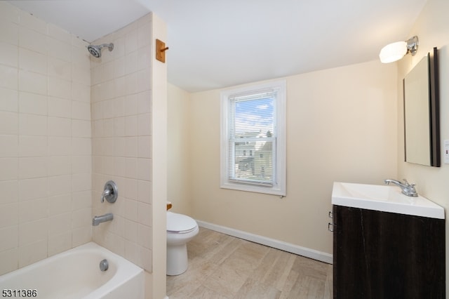 full bathroom with vanity, toilet, and tiled shower / bath combo