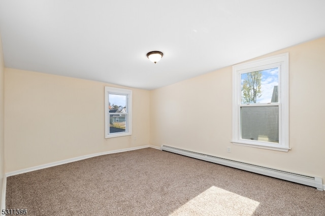 carpeted spare room with lofted ceiling, a baseboard heating unit, and plenty of natural light