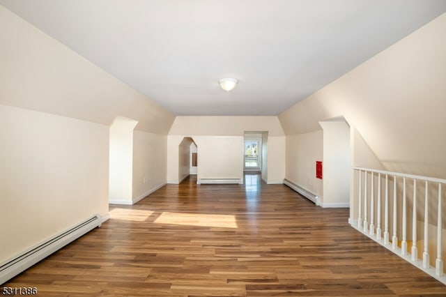 additional living space featuring hardwood / wood-style flooring, lofted ceiling, and a baseboard radiator