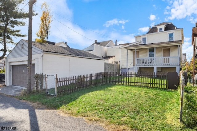 view of front of home with a front yard, a garage, and covered porch