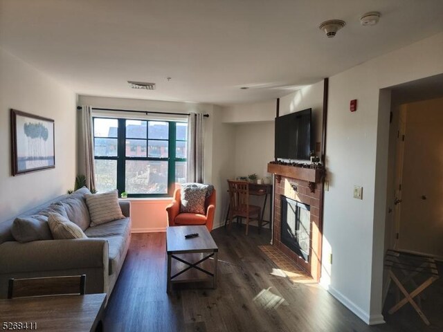 living room featuring a fireplace and dark hardwood / wood-style floors