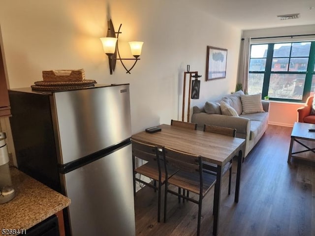 dining space featuring visible vents and dark wood finished floors