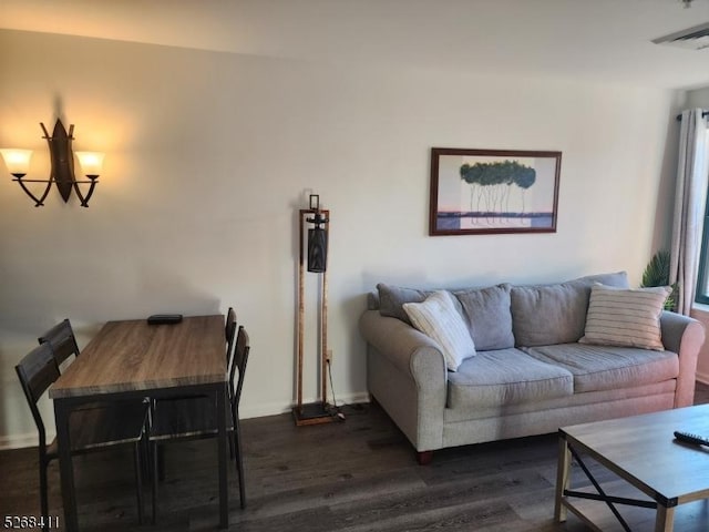 living room featuring dark wood-type flooring and visible vents