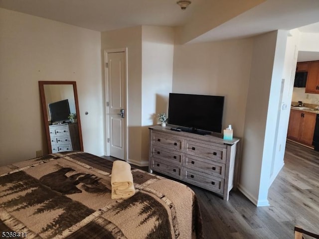 bedroom featuring dark wood-type flooring and baseboards