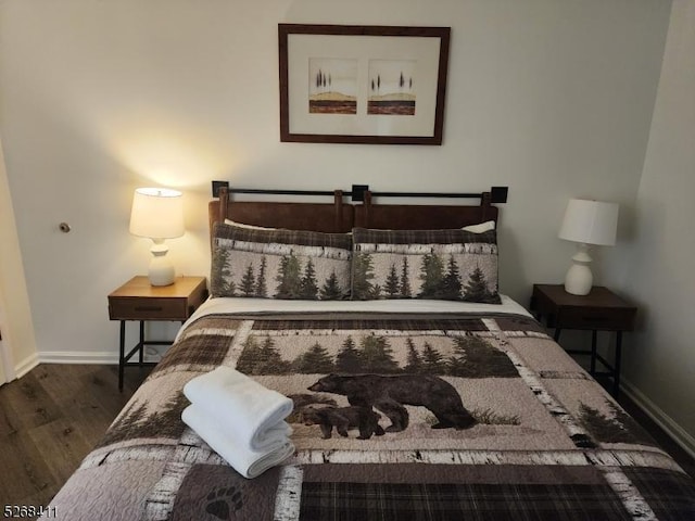 bedroom with wood finished floors and baseboards