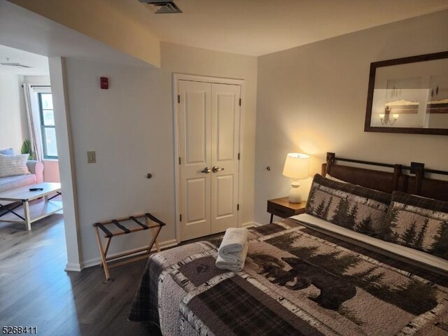 bedroom featuring dark hardwood / wood-style flooring and a closet