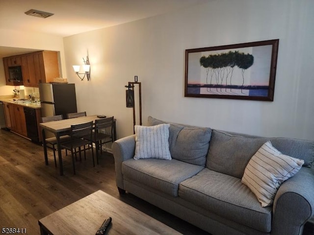 living area featuring dark wood-style floors and visible vents