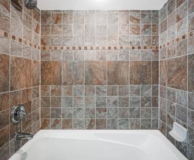 bathroom featuring washtub / shower combination