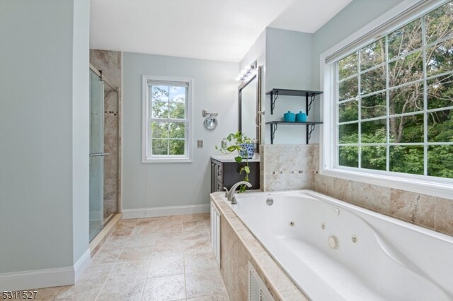 bathroom featuring tile patterned flooring, vanity, a wealth of natural light, and shower with separate bathtub