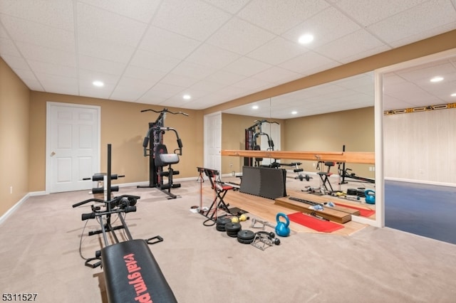 workout area with carpet floors and a drop ceiling