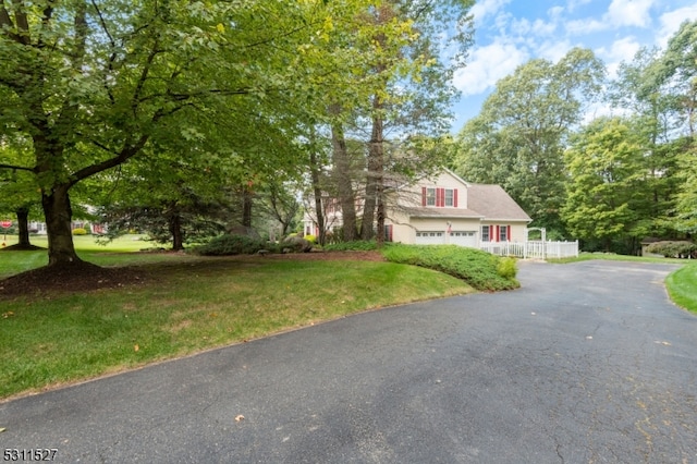 view of front of house featuring a front yard and a garage