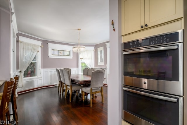 dining area with a chandelier and dark hardwood / wood-style flooring