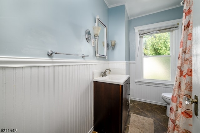 bathroom featuring crown molding, vanity, toilet, and tile patterned flooring