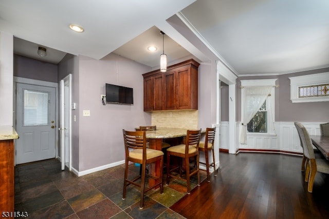 dining room featuring ornamental molding and dark wood-type flooring