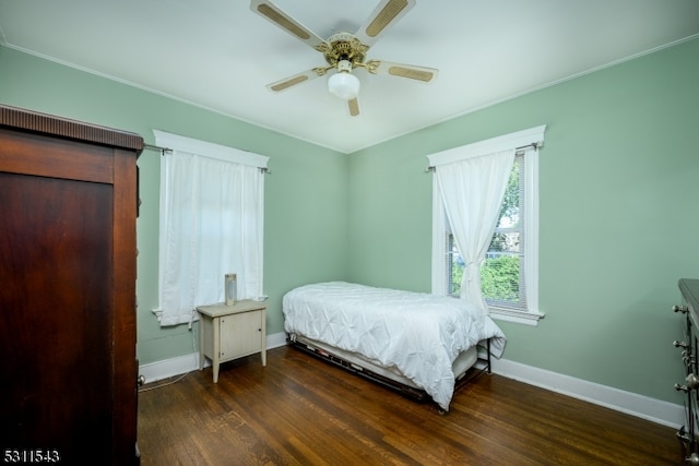 bedroom with ceiling fan and dark hardwood / wood-style flooring