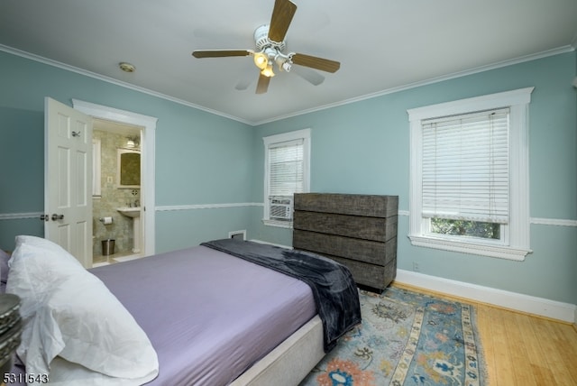 bedroom with ceiling fan, ornamental molding, ensuite bath, and light wood-type flooring