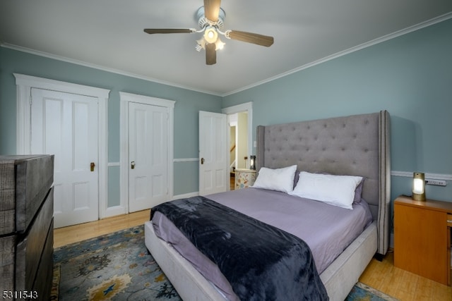 bedroom with ornamental molding, hardwood / wood-style flooring, and ceiling fan