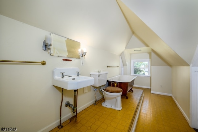 bathroom featuring lofted ceiling and toilet