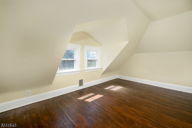 additional living space featuring lofted ceiling and hardwood / wood-style flooring