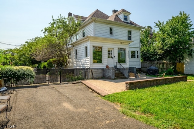 rear view of house featuring a yard