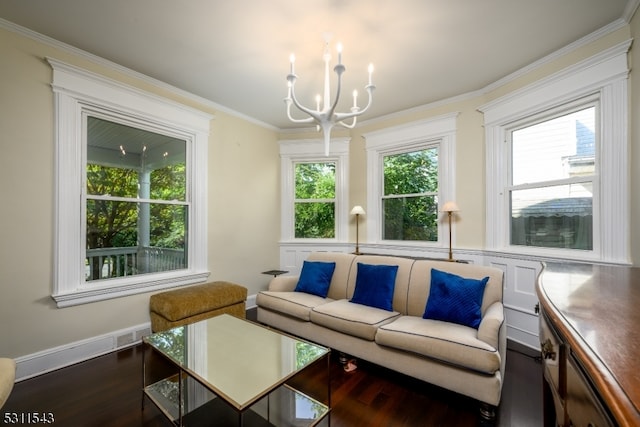 living room featuring crown molding, dark hardwood / wood-style flooring, a healthy amount of sunlight, and an inviting chandelier