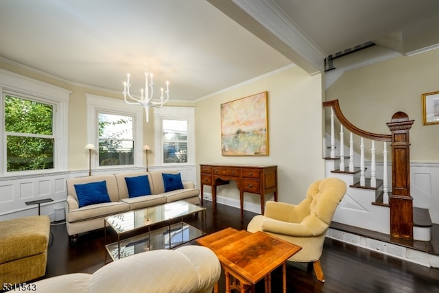 living room with dark hardwood / wood-style floors, an inviting chandelier, and ornamental molding