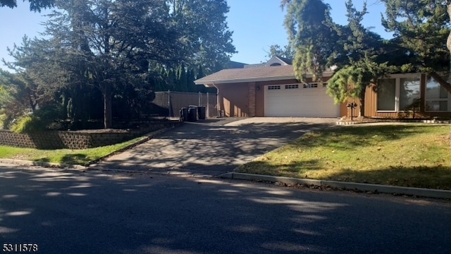 view of front facade with a front lawn and a garage