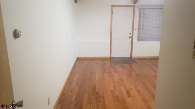 hall with light hardwood / wood-style floors