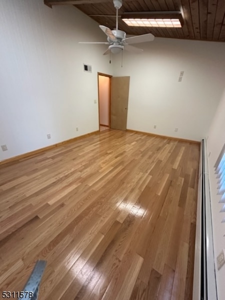 empty room with light hardwood / wood-style flooring, wood ceiling, high vaulted ceiling, and ceiling fan