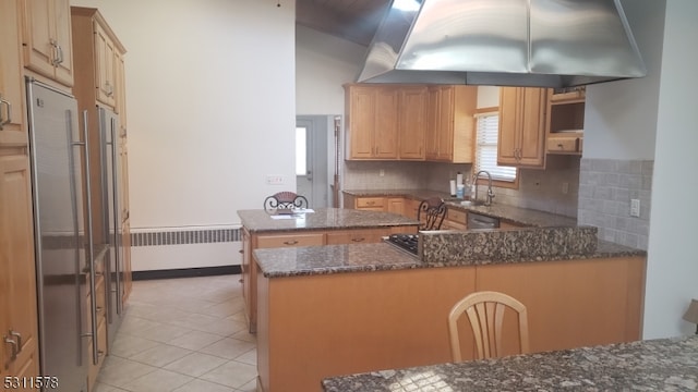 kitchen featuring island range hood, radiator, kitchen peninsula, backsplash, and light tile patterned floors