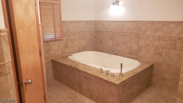 bathroom featuring tiled tub, tile walls, and tile patterned flooring