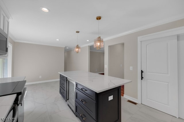 kitchen with pendant lighting, light stone counters, a center island, and ornamental molding