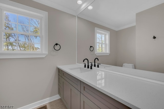 bathroom featuring crown molding, vanity, and toilet