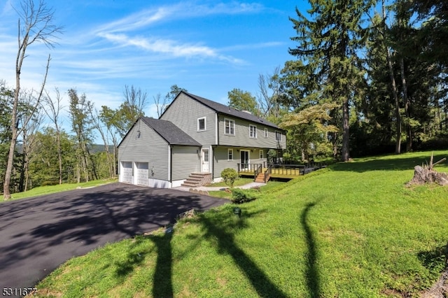 view of front of house featuring a front yard and a garage