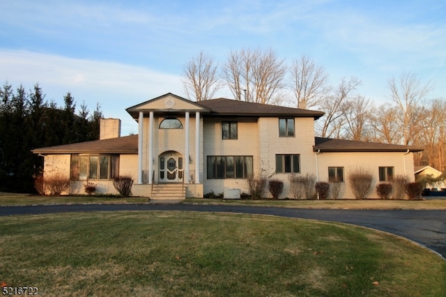 greek revival house featuring a front lawn