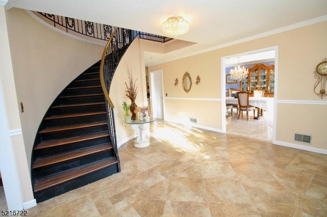 staircase featuring crown molding and a notable chandelier