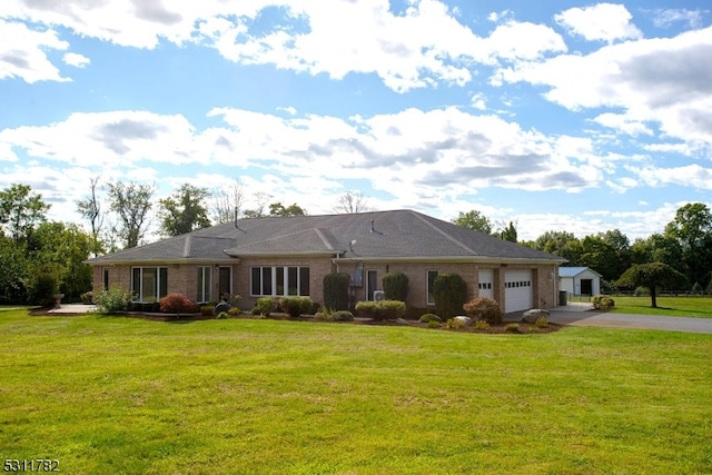 ranch-style home featuring a garage and a front yard